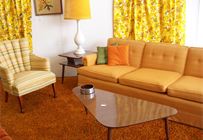 Retro Orange Sofa with pie shaped coffee table.