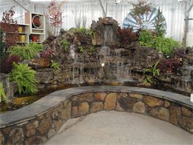 Waterfall Room : The Waterfall Room is the most sought after space in our warehouse for events. It features a three falls water and fire feature. The Industrial Decor and Displays also make it a unique environment for any occasion. Ask us about our Foliage and Flower package for your event. We can transform our warehouse into a garden oasis. Waterfall Room